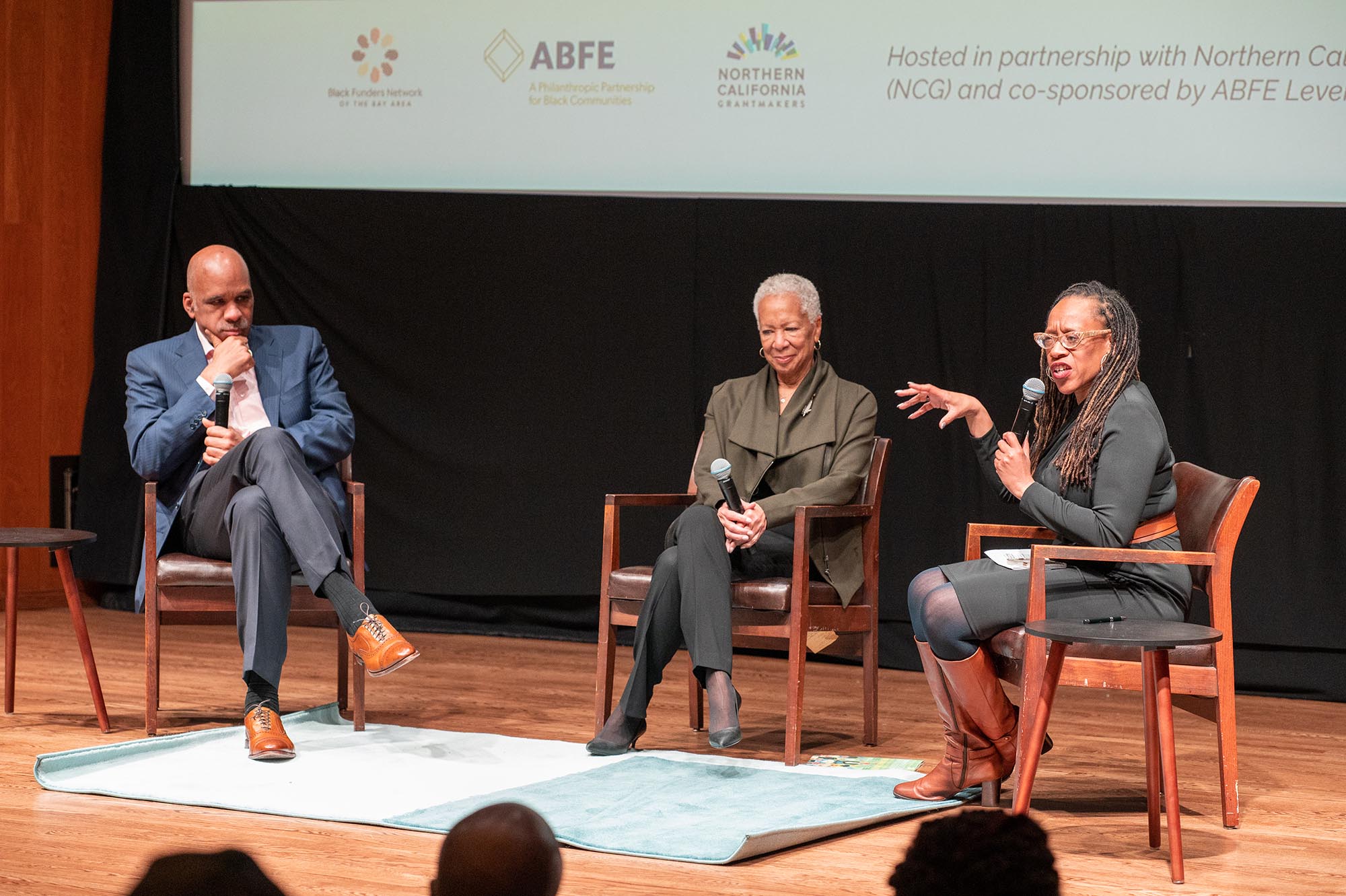 Three black people on stage at 2023 Black History Month Funder Reception