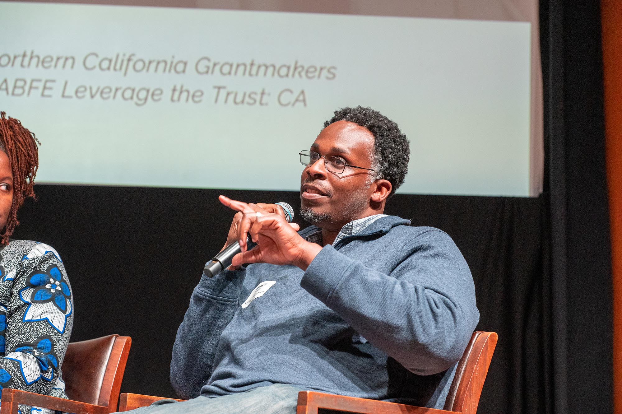 black man speaking into microphone