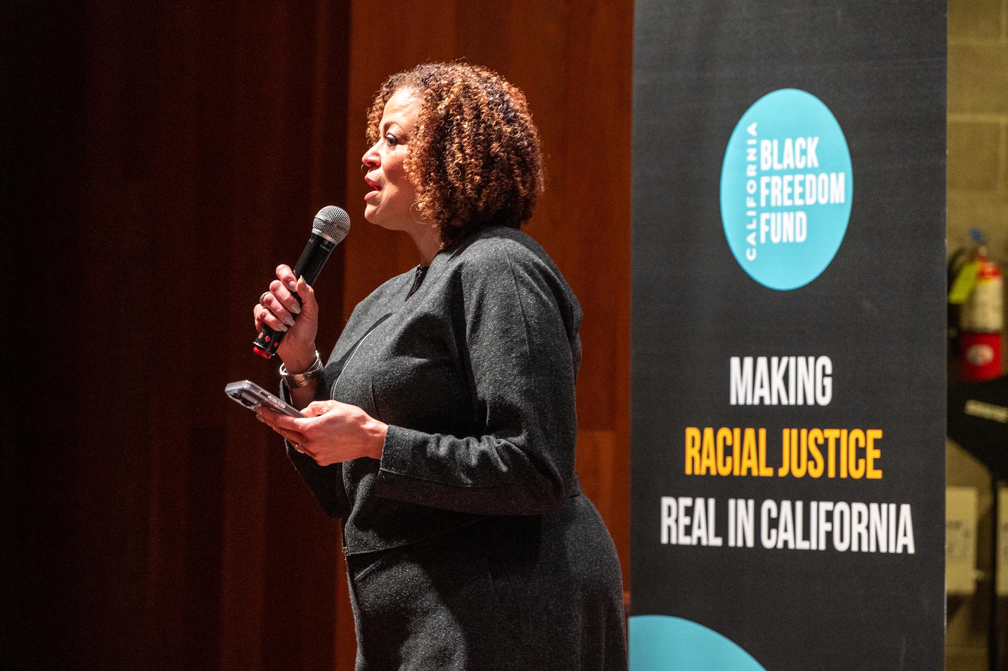 black woman speaking into microphone
