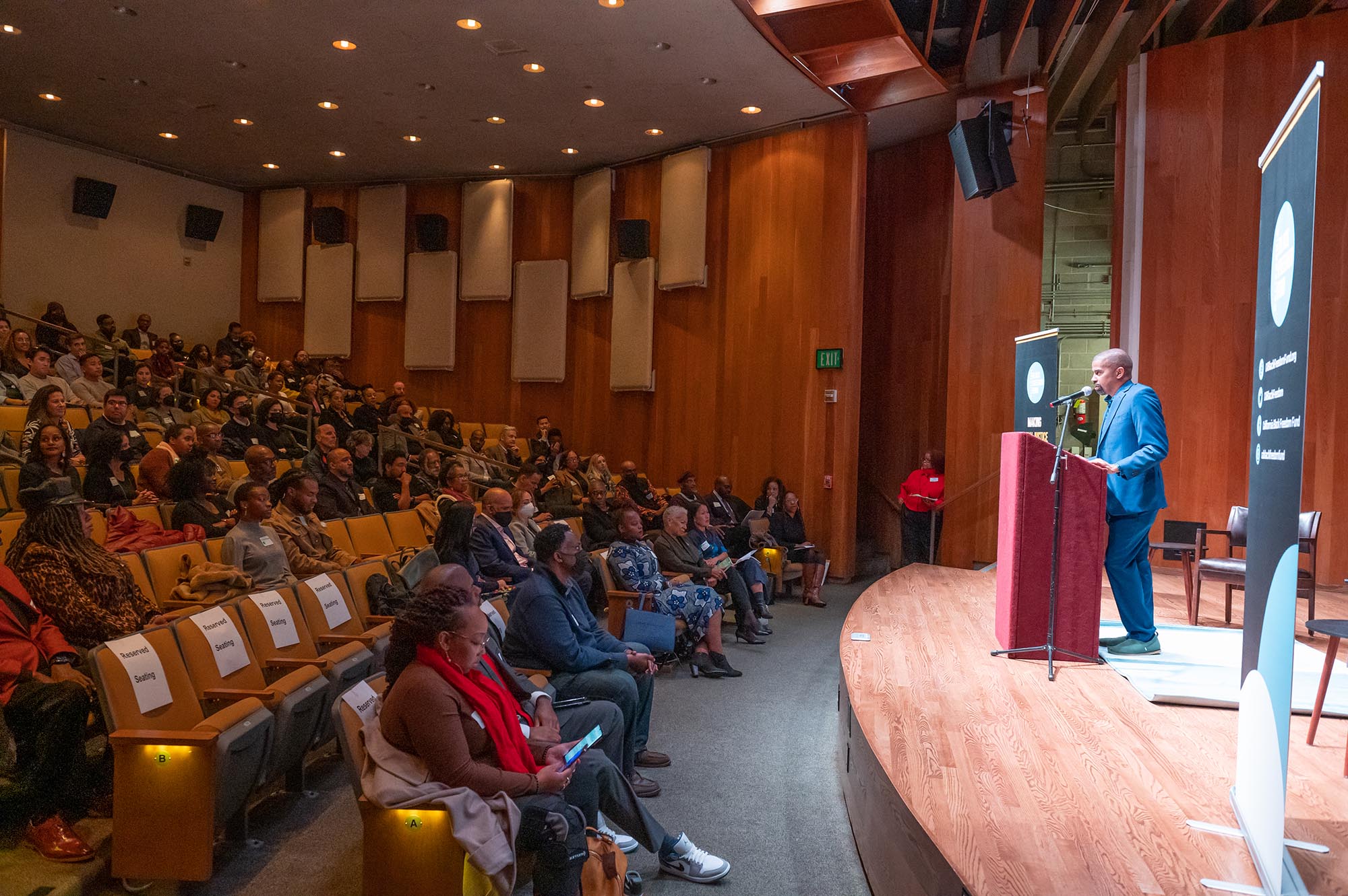 Man speaking from podium on stage at 2023 Black History Month Funder Reception