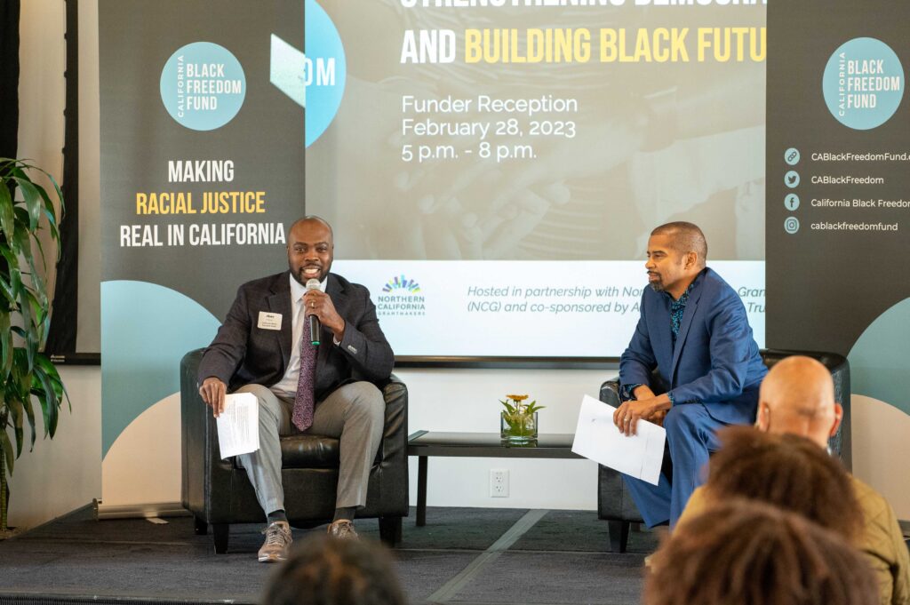 two men on stage talking