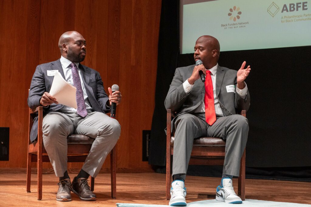 Two men on stage talking