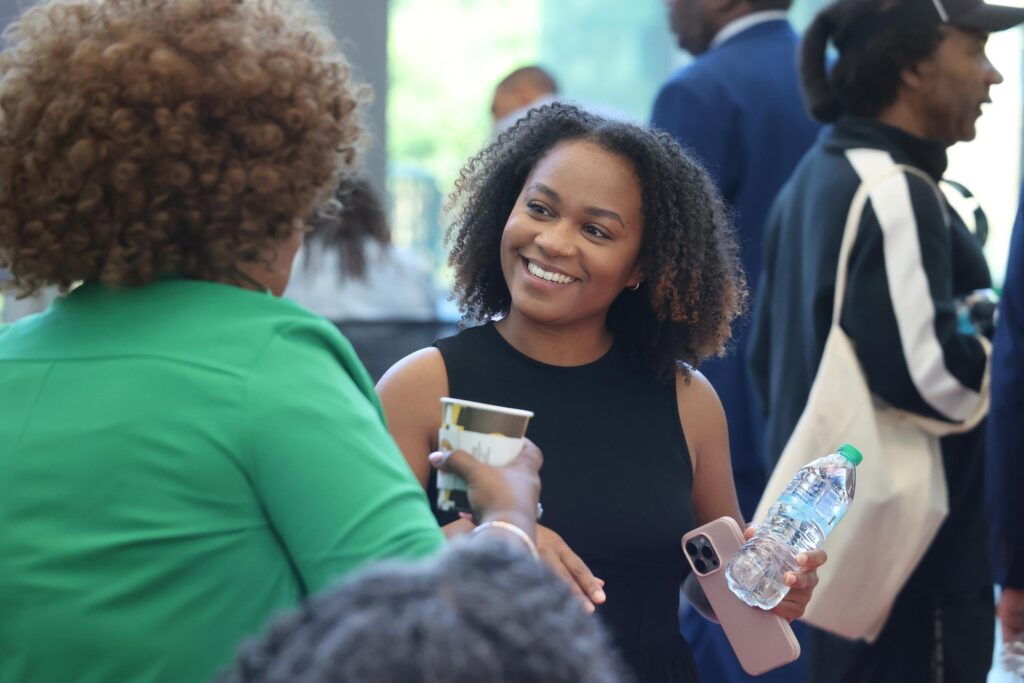 Woman smiling and talking to another woman
