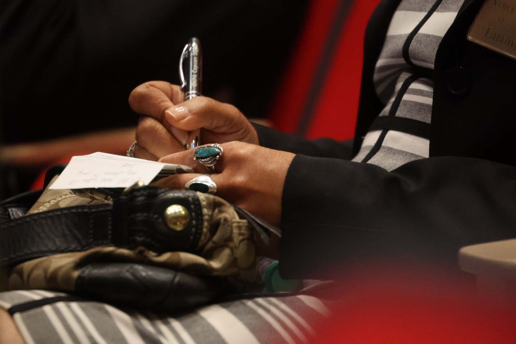 The State of Black California event series kicked off in San Diego on Juneteenth weekend - hands taking notes