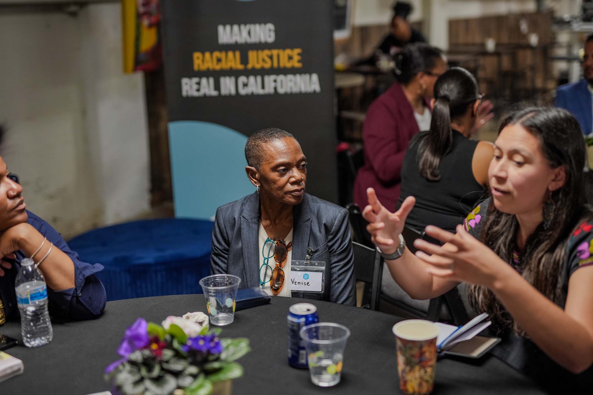 woman speaking with her hands at a table