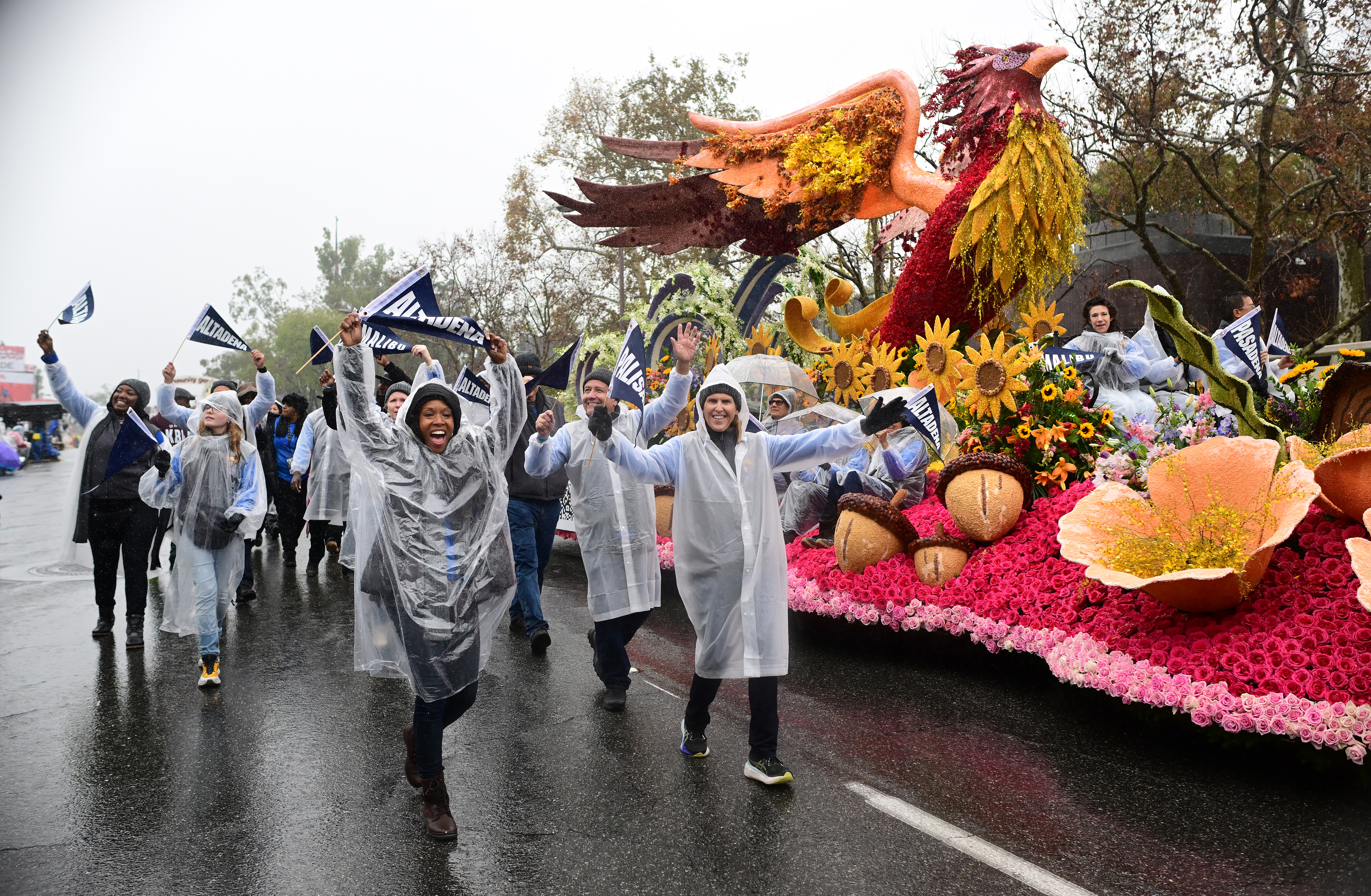 Palisades and Eaton Fire survivors walk alongside the Rising Together float during the Rose Parade